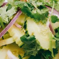 Cucumber Salad* · Sliced cucumber with red onion and cilantro, atop with sweet vinaigrette.