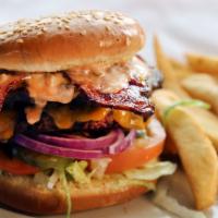 Western Bbq Burger · Grilled 1/3 pound beef patty topped with cheddar cheese, two pieces of bacon, grilled onions...