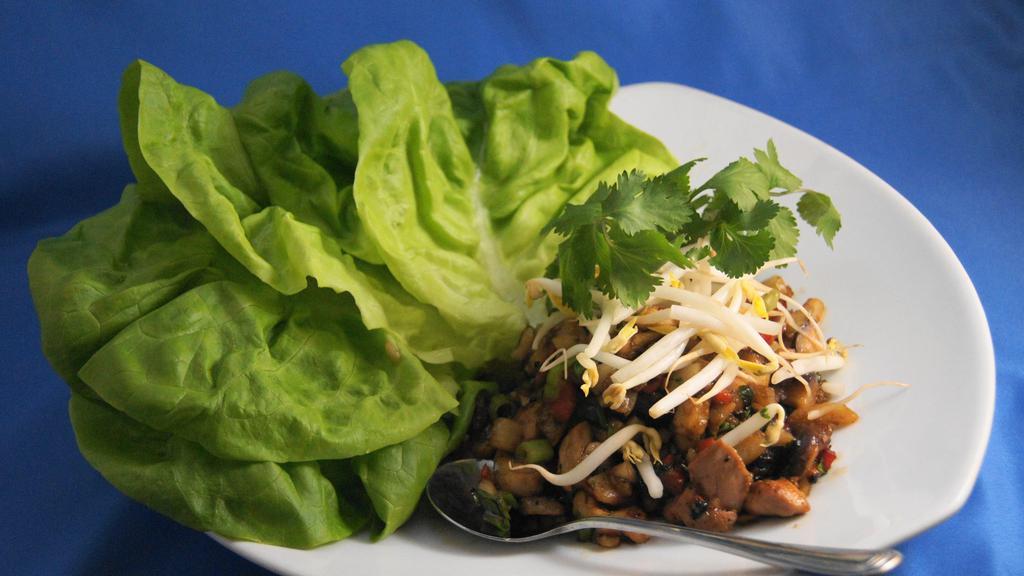 Ginger Chicken Lettuce Wraps · Wok seared ginger chicken, braised shiitake mushrooms & water chestnuts served with tender butter lettuce.
