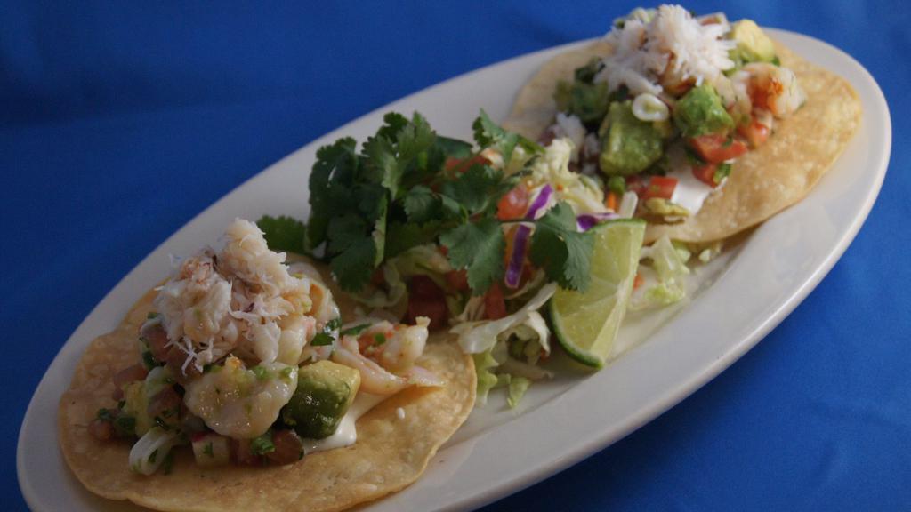 Ceviche Tostada Salad · Chile-lime marinated shrimp, crab & calamari, avocado, tomato, cilantro & crisp white corn tortillas.