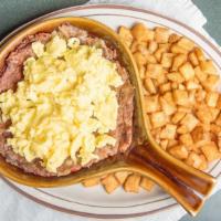 Homemade Corn Beef Hash · Corn beef hash grilled then topped with two eggs any style and served with habla diablo seas...
