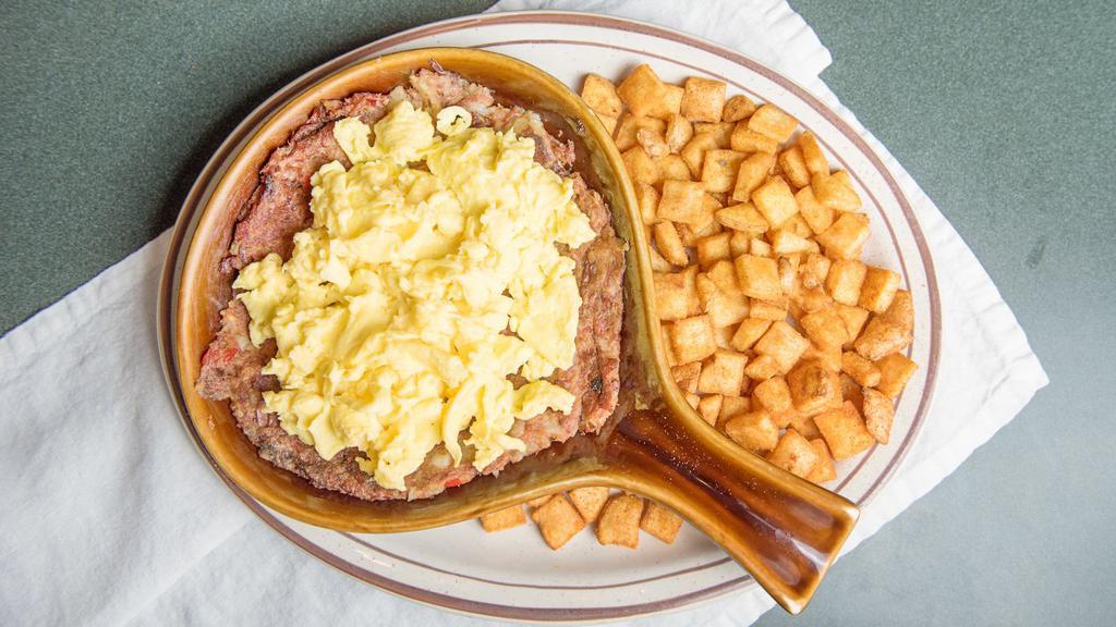 Homemade Corn Beef Hash · Corn beef hash grilled then topped with two eggs any style and served with habla diablo seasoned potatoes, and your choice of toast or banana nut muffin.