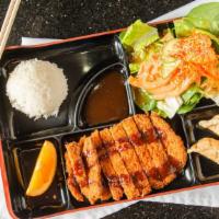 Chicken Katsu · Deep fried breaded chicken breast with tonkatsu sauce, white rice, two gyoza, slice of orang...