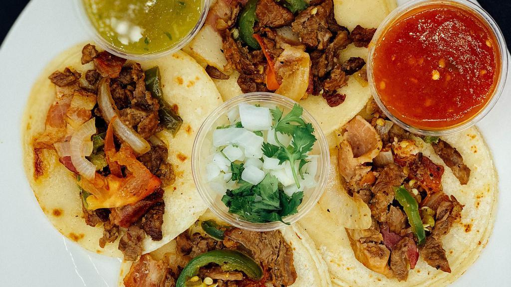 Albanil Taco Order · Four tacos at the meat of your choice, with red or green chili sauce.