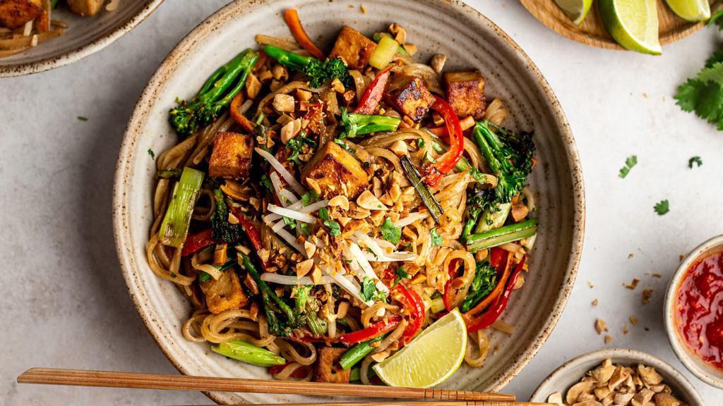 Pad Thai (Veg) · Stir-fired rice noodles with tamarind sauce, tofu, chive and bean sprout. Served with chopped peanut and lemon slice.