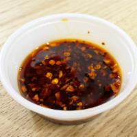 Chili Oil · Soybean oil infused with Thai Herbs mixed with spices and Thai dried chili. Very spicy!!!