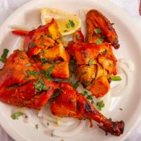 Tandoori Chicken (Half-4 Pieces) · Bone-in chicken on a bed of bell peppers and onions.