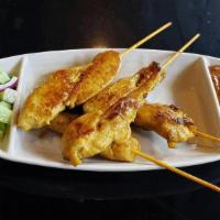 Chicken Satay · Marinated chicken tender in curry powder, coconut milk and Thai spices. Broiled and served w...