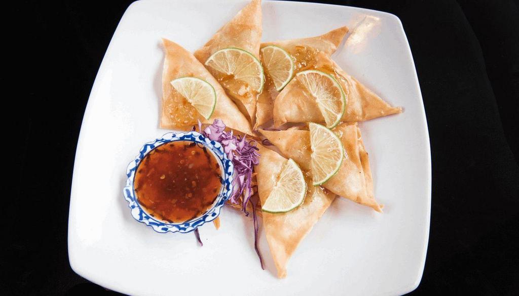 Lime Chicken · Marinated ground chicken wrapped in spring roll wrapper. Deep fried and finished with orange marmalade glaze and slice of lime. Served with sweet chili sauce.