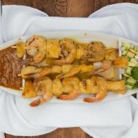 Prawns Satay · Marinated chicken tender in curry powder, coconut milk and Thai spices. Grilled and served w...