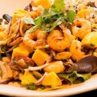 Lemongrass Prawns Salad · Bed of lettuce topped with prawns, red and green onion, lemongrass, cilantro and mango in li...