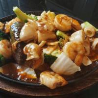 Puget Seafood In Hot Pan · Stir-fried combination seafood in sweet and sour chili sauce. Served on bed of steamed veget...