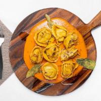 Cappelletti Di Zucca · Homemade small hat shaped ravioli filled with roasted butternut squash, walnuts, and parmesa...