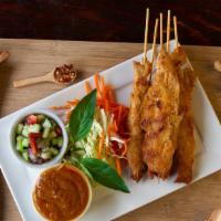 Kai Satay 4 Skewers · Gluten-free. Grilled chicken breast marinated with coconut milk and curry spice, served with...