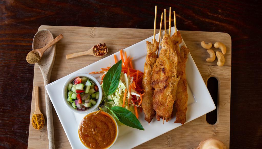Kai Satay 4 Skewers · Gluten-free. Grilled chicken breast marinated with coconut milk and curry spice, served with homemade peanut sauce and cucumber salsa.