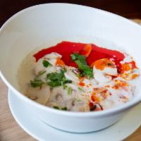 Tom Kha Chicken · Thai Coconut milk in lemongrass chicken soup  with tomato, onion and mushroom . 32 oz large ...