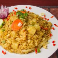 Pineapple Fried Rice · Stir-fried rice with eggs, carrot, green onion, Pineapple, tomato, curry powder and roasted ...
