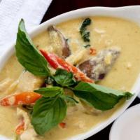 Green Curry Served With Rice · Green curry with coconut milk, eggplant, bell pepper, bamboo shoots, basil