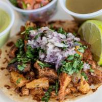 Al Pastor Taco · Pork street taco marinated with pineapple, chili's and spices of garlic and clove. Topped wi...