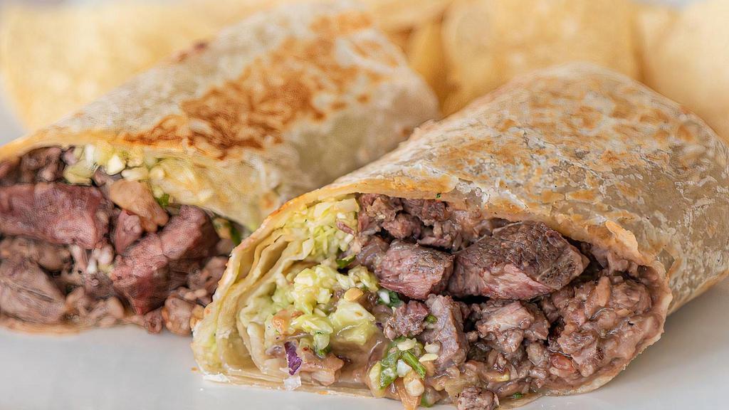Steak Burrito · Flour tortilla filled with refried beans, mesquite grilled carne asada, diced cabbage, diced red onion, pico de gallo, guacamole salsa and secret red tomato sauce.