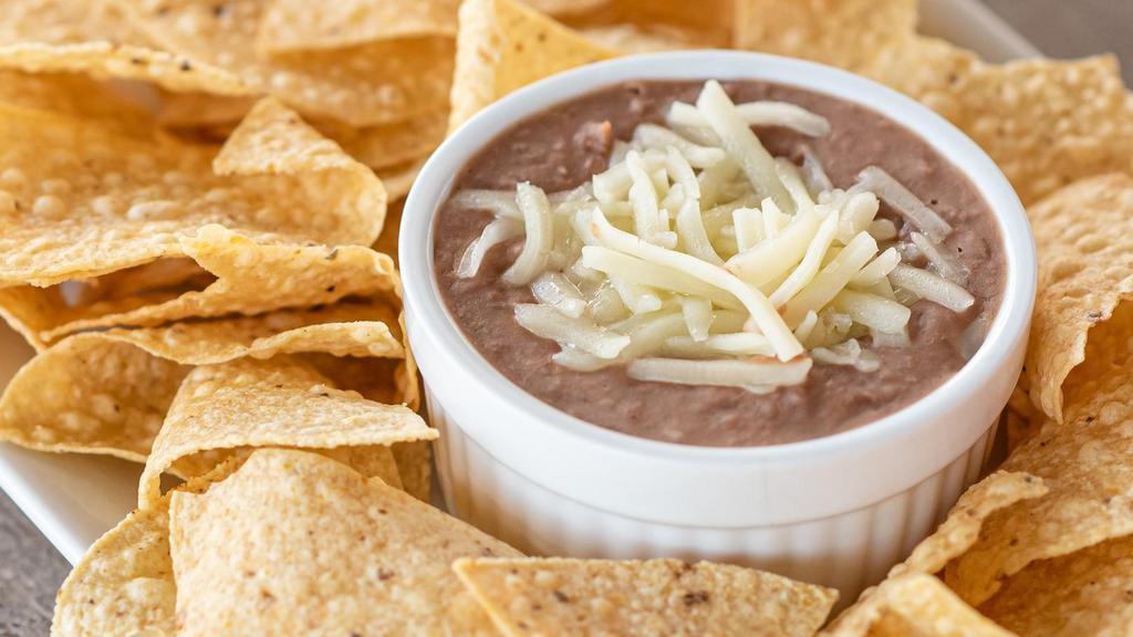Chips And Beans · Refried Beans topped with Monterey Jack Cheese and served with corn tortilla chips.