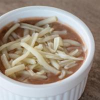 Refried Beans · Refried Beans topped with Monterey Jack cheese.