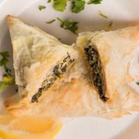 Spanakopita · Spinach and feta wrapped in flaky fillo.