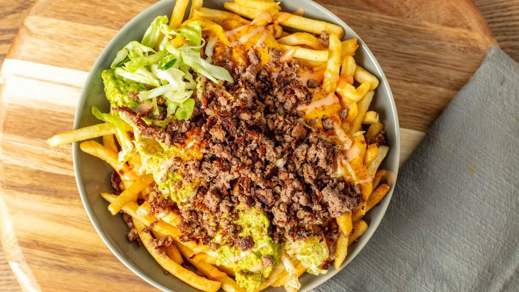 Solár Loaded Fries · Large plate of fries topped with Impossible Meat, house specialty coleslaw, guacamole aioli, cheese sauce, and Solár Sauce.
100% Plant-Based Vegan.