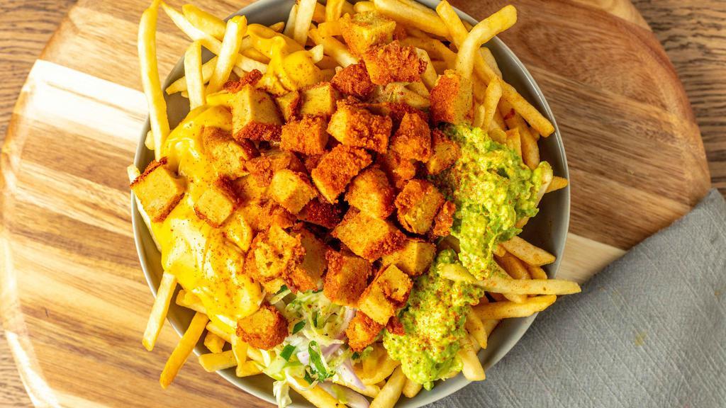 Solár Loaded Chicken Fries · Vegan Nashville Hot Chicken tenders shredded and seasoned on a large plate of fries. Comes with guacamole, cheese sauce, coleslaw, and Solár Sauce.
100% Plant-Based Vegan.