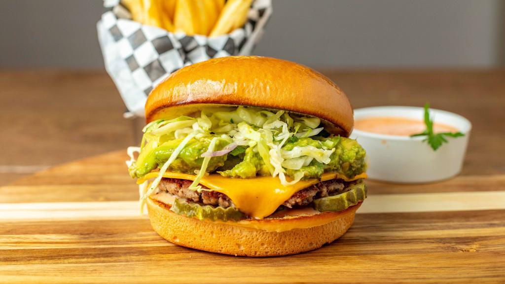 The Solár Burger Combo · Two 1/4lb patties of Impossible Meat, topped with pickles, grilled onions, Solár sauce, two slices of vegan cheese, and a heaping serving of guacamole. Served with a side of fries, a drink and a side of Solár Sauce.
100% Plant-Based Vegan.