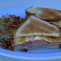 Breakfast Sandwich · English Muffin, Fried Egg, American Cheese, Bacon, Sausage or Ham w/ Hash Browns