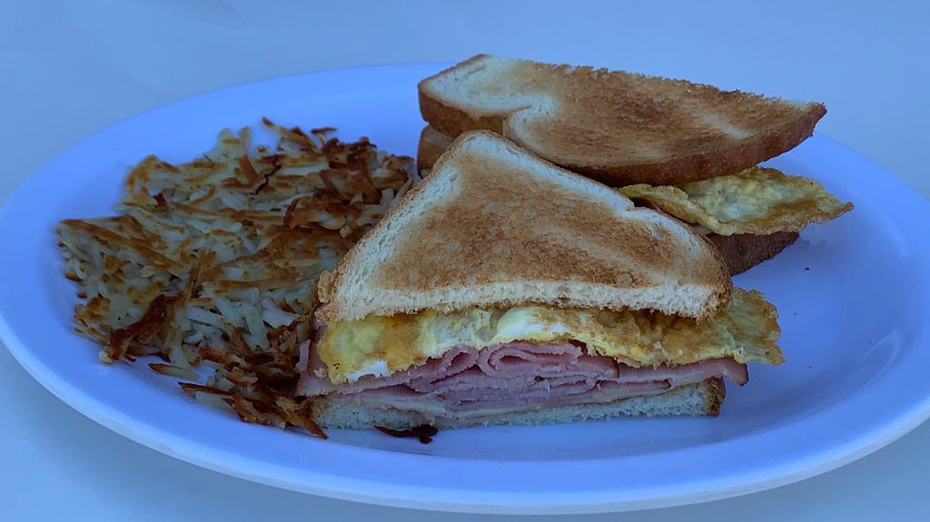 Breakfast Sandwich · English Muffin, Fried Egg, American Cheese, Bacon, Sausage or Ham w/ Hash Browns