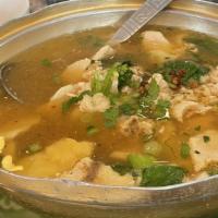 Wonton Soup (Vegetables Or Tofu) · Dumplings with spinach in clear broth with cilantro leaves on top.