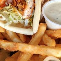 Fried Chicken Pita · Diced crispy fried chicken tossed in your choice of wing sauce. Served with lettuce, tomato ...