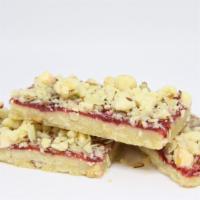 Raspberry Jammer · Shortbread topped with raspberry and shaved almonds.