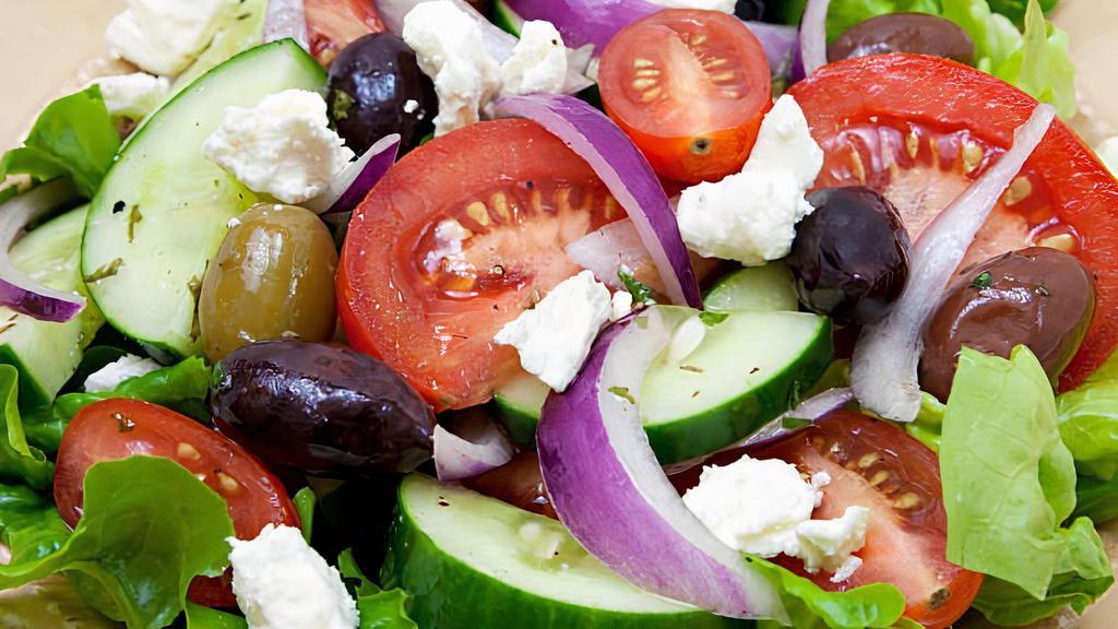 Greek · Romaine, feta cheese, pesto, olives, onion, cucumber, tomato, lemon juice, salt, pepper, and olive oil.