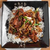 Mongolian Beef · Hot and spicy. Sliced beef sautéed with scallion and onion in brown sauce on top of crispy w...