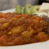 Huevos Rancheros · Served with housemade tomato sauce, eggs, beans, cheese, cream, avocado and two tortillas.