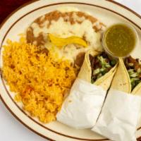 Carne Asada Tacos · Two tacos with grilled beef, cilantro, and onions. Served with rice, beans, and green salsa.
