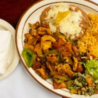Fajitas Dinner · Your choice of specially marinated steak, spicy pork, or tangy chicken. Strips sautéed in be...