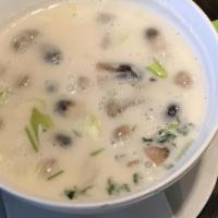 Tom Kah · Coconut milk soup with fresh mushroom, onion, tomato, cilantro and Thai spices.