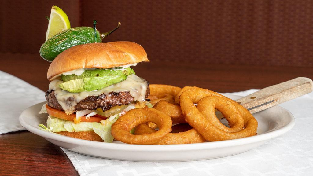 South Of The Border Burger · 8 oz. Certified Angus beef patty* with Jack cheese, onions, tomatoes, lettuce, pickles, avocado, fried jalapeño and mayo on a brioche bun.