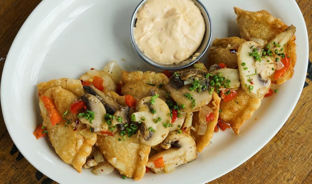 Potato Pierogies · Boiled or fried, stuffed with cheese and potatoes. Garnished with mushrooms, onions, garlic, and red pepper flake. Served with a side of spicy pierogi sauce.