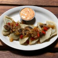 Spinach Pierogies · Boiled or fried, stuffed with feta and spinach. Garnished with mushrooms, onions, garlic, an...