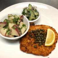 Pork Schnitzel · Topped with lemon and capers. Served with a side of potato salad and your choice of cucumber...