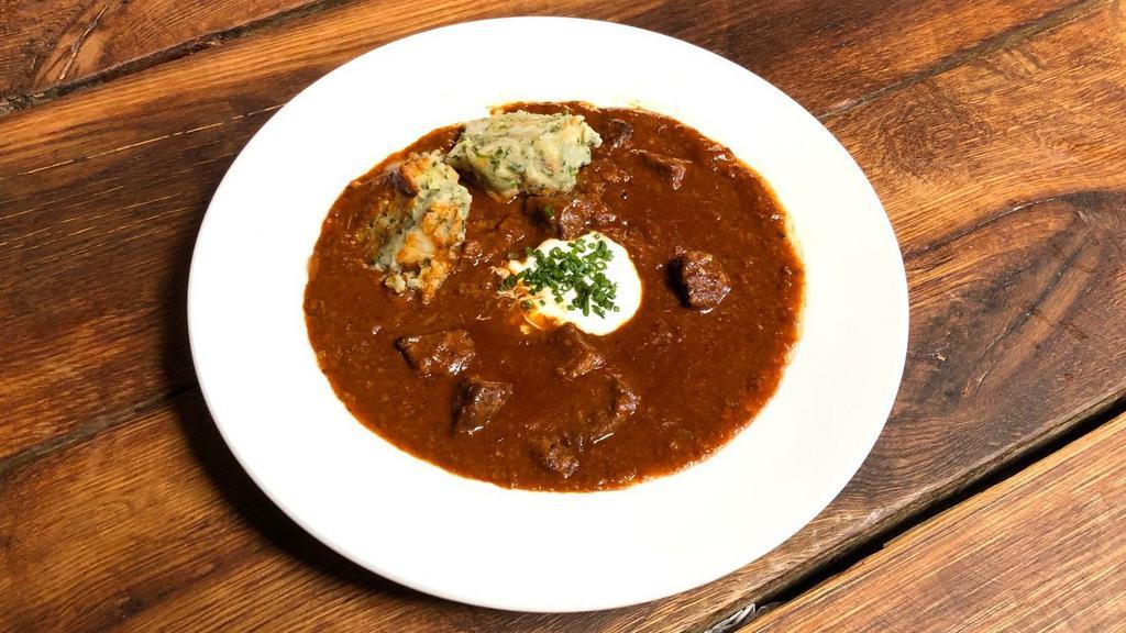 Bohemian Beef Goulash · Made with finely cut pieces of beef and paprika and onion sauce. Served with classic Czech bread dumplings.