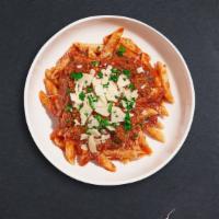 Bolognese Pasta · Fresh Cavatappi pasta cooked in a meaty red sauce and topped with black pepper, parsley, and...