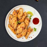 Sweet Chili Wings · Fresh chicken wings breaded, fried until golden brown, and tossed in sweet chili sauce. Serv...