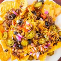 Cheezy Nachos W/Steak Or Chicken  · Loaded with Jalapenos, Tomatoes, Green Onions, onions, Salsa Asada, Olives, Sour Cream, & Gu...