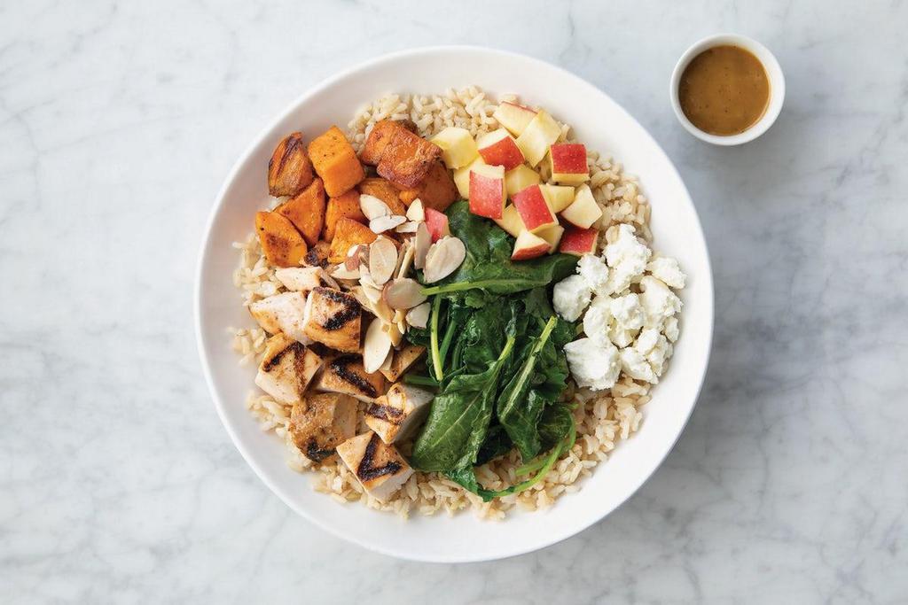 Harvest Bowl · Grilled chicken, spiced sweet potatoes, organic apples, goat cheese, toasted almonds, sauteéd organic baby kale, and balsamic vinaigrette on a bed of brown rice.